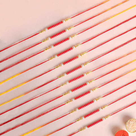 Assortment of 12 Rakhis, featuring different designs, threads, and embellishments for Raksha Bandhan. India’s Largest Pooja Accessories Brand - www.satvikstore.in