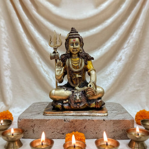  Brass Idol of 17.5 Inch Brass Lord Shiva Statue in Meditation Pose. Embodying peace and spiritual focus, this 17.5-inch Brass Shiva Idol features Lord Shiva in a serene meditative posture. Known as the ultimate yogi, Lord Shiva is beautifully represented here with intricate detailing in brass, capturing the tranquility and profound wisdom of his meditation on. India's Largest Puja Accessories Brand - Satvik No 1 Brass Idol Collection.