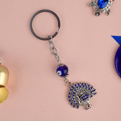 Aura Evil Eye Peacock Keychain – A stylish good luck and protective charm symbolizing grace and positivity. India’s Largest Pooja Accessories Brand – www.satvikstore.in
