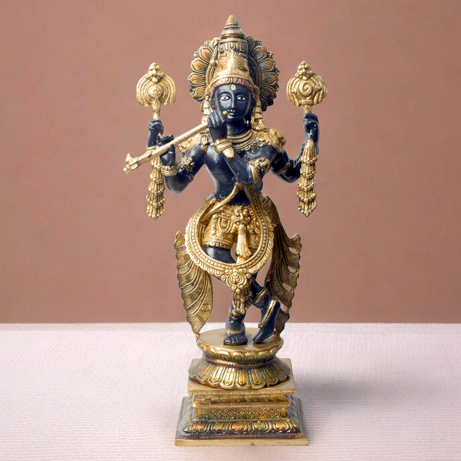 Large Brass Idol of 19 Inch Brass Chola Krishna Sculpture Playing the Flute. Bring home the divine charm of Lord Krishna with this exquisite 19-inch Brass Chola Krishna Sculpture. Expertly crafted, this statue captures Lord Krishna in his iconic pose, gracefully playing the flute.