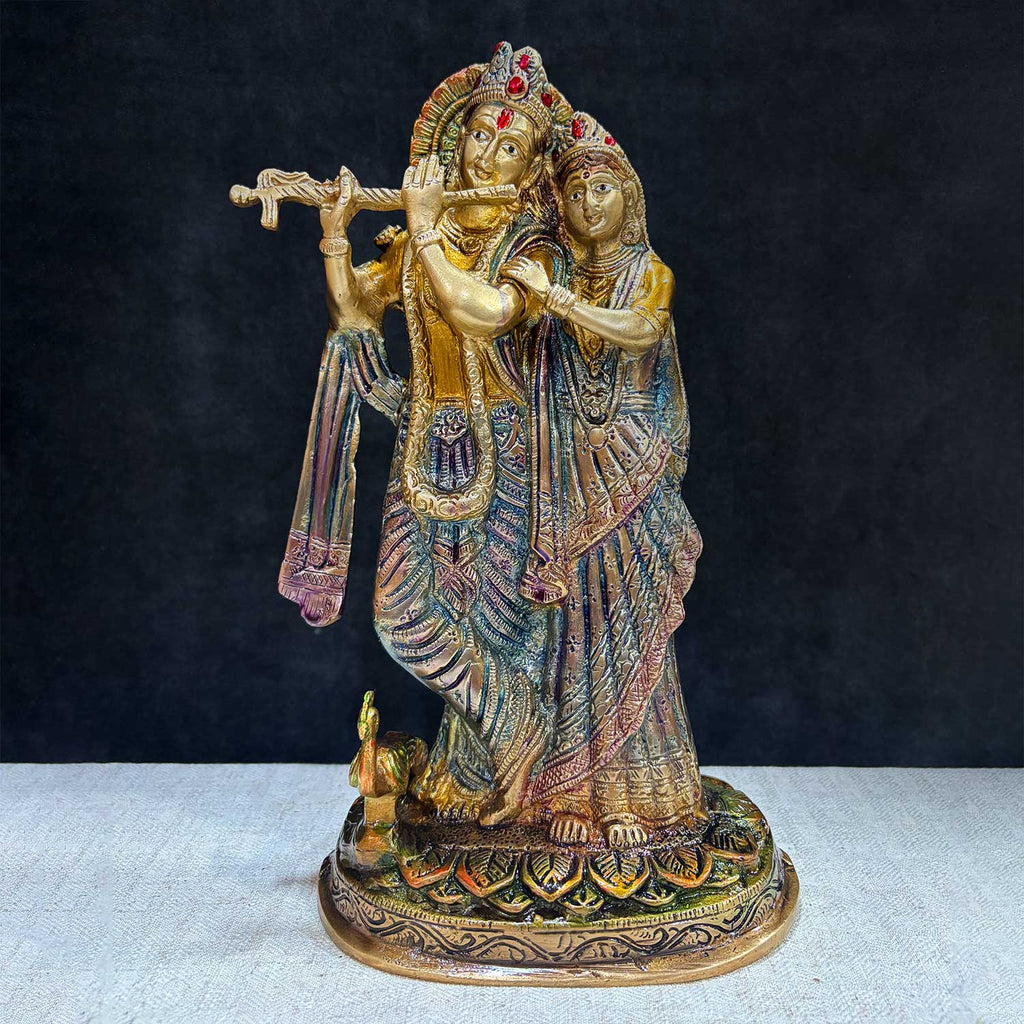 The 11.4-inch Radha Krishna –-Divine Harmony in a Sacred Sculpture is a breathtaking masterpiece that captures the eternal and divine bond between Radha and Krishna. This beautifully detailed idol showcases the couple in a serene and harmonious pose, with Krishna playing his mesmerizing flute and Radha standing gracefully by his side. India's Largest Puja Accessories Brand - Satvik No. 1 Brass Idol Collection 