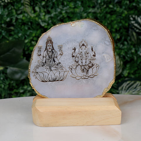 Agate stone stand featuring intricate hand-painted images of Goddess Laxmi and Lord Ganesha, symbolizing prosperity, wealth, and divine blessings, placed elegantly on a wooden base for spiritual home decor. India’s Largest Pooja Accessories Brand – www.satvikstore.in