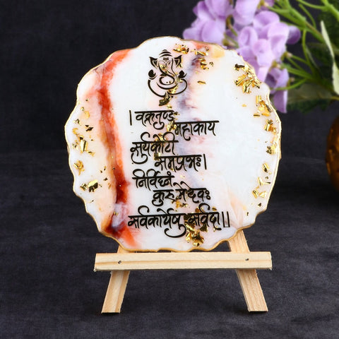 Decorative Ganesha Mantra frame with a built-in stand, crafted in epoxy resin, featuring a divine depiction of Lord Ganesha and sacred mantra inscriptions. India’s Largest Pooja Accessories Brand – www.satvikstore.in